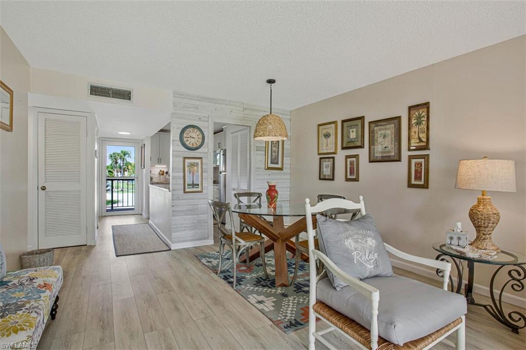 4380 27th Court Southwest, Unit 202 Naples, FL 34116 - Photo 21 of 24 a living room with furniture and wooden floor