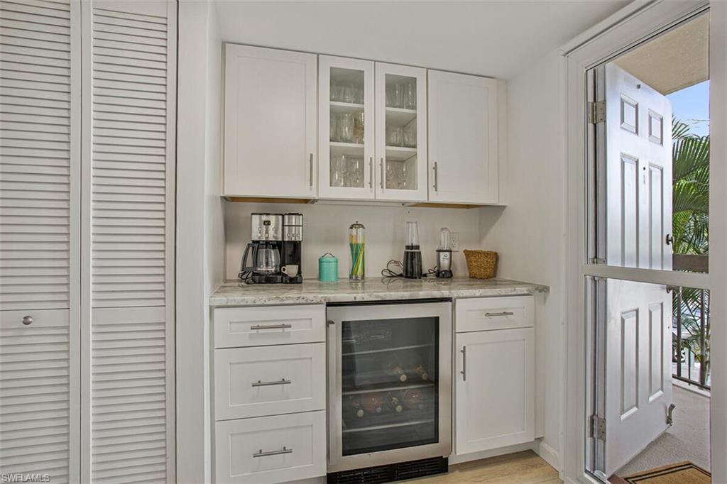 4380 27th Court Southwest, Unit 202 Naples, FL 34116 - Photo 4 of 24 a kitchen with cabinets and window