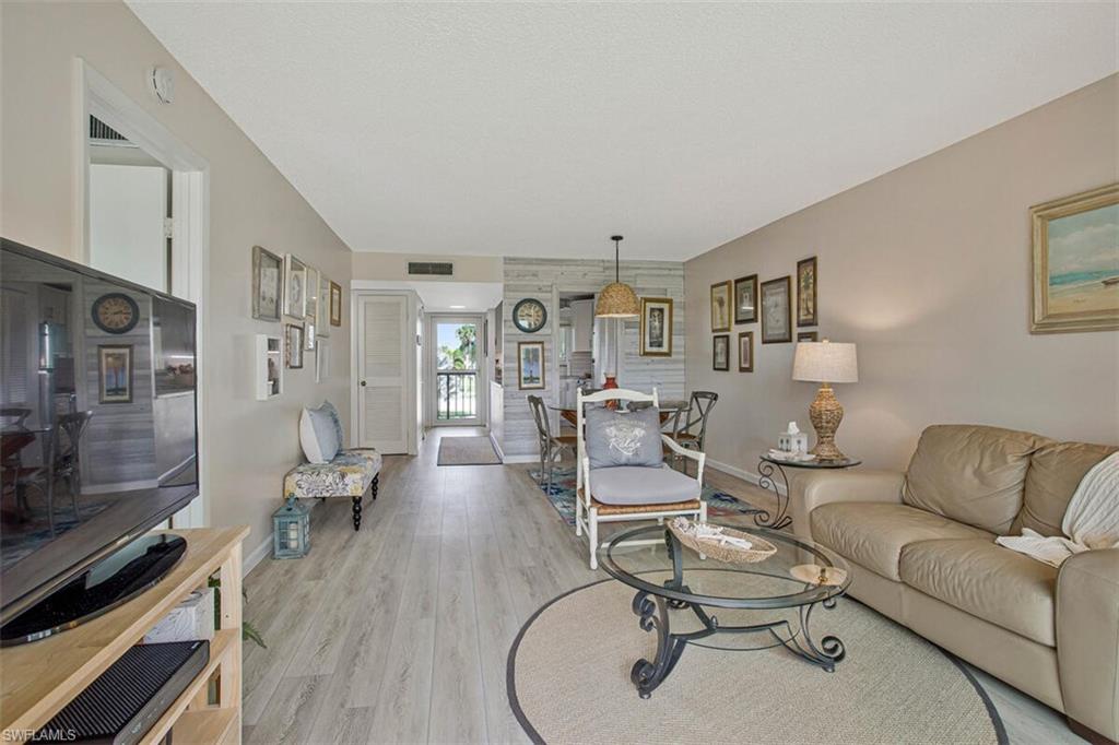 4380 27th Court Southwest, Unit 202 Naples, FL 34116 - Photo 8 of 24 a living room with furniture