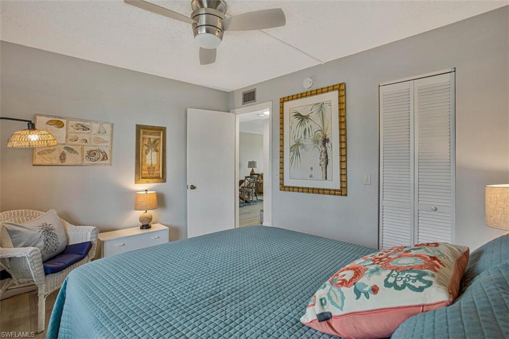 4380 27th Court Southwest, Unit 202 Naples, FL 34116 - Photo 9 of 24 a bedroom with bed and two window
