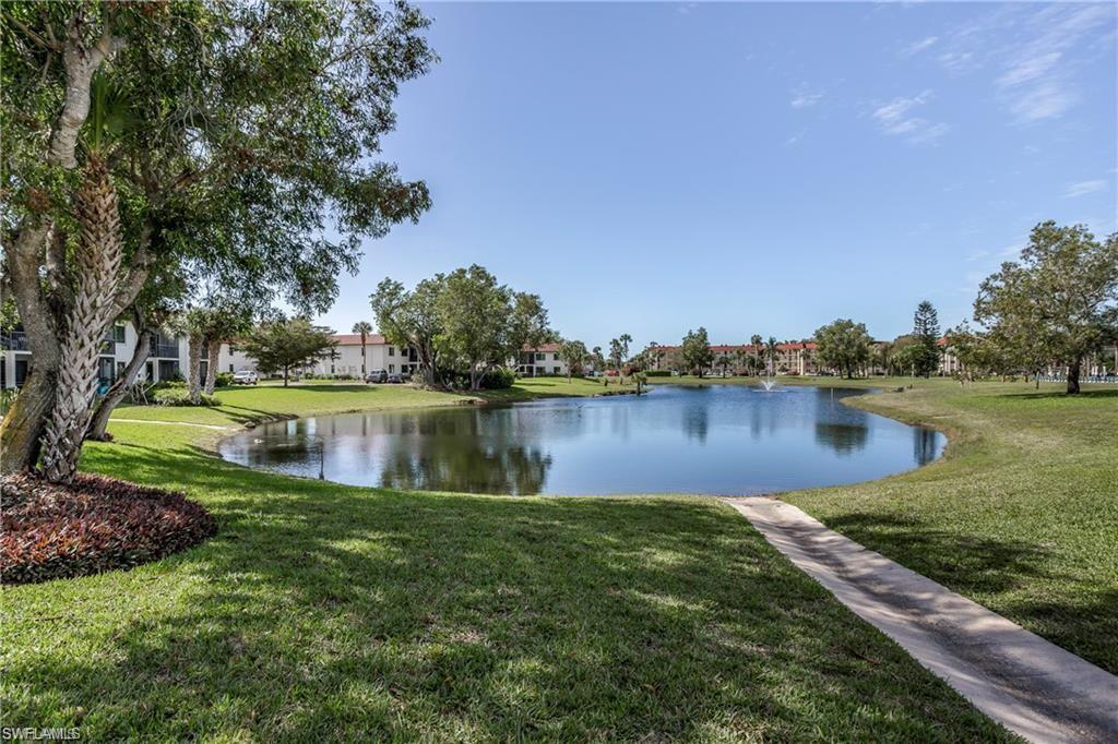4380 27th Court Southwest, Unit 202 Naples, FL 34116 - Photo 10 of 24 a view of a lake with houses in the back