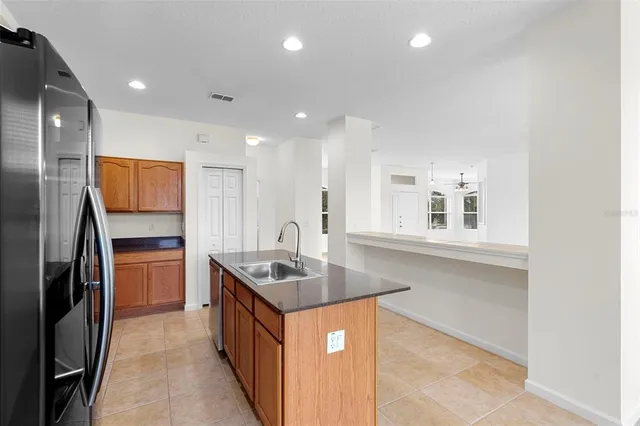 a kitchen with stainless steel appliances granite countertop a stove a refrigerator and a sink