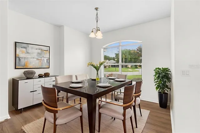 a view of a dining room with furniture window and wooden floor