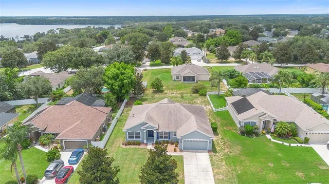 an aerial view of residential houses with outdoor space and swimming pool