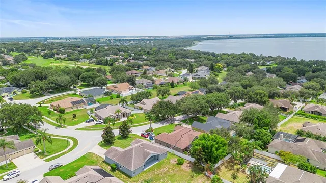 an aerial view of residential houses with outdoor space and street view
