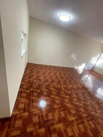 an empty room with wooden floor