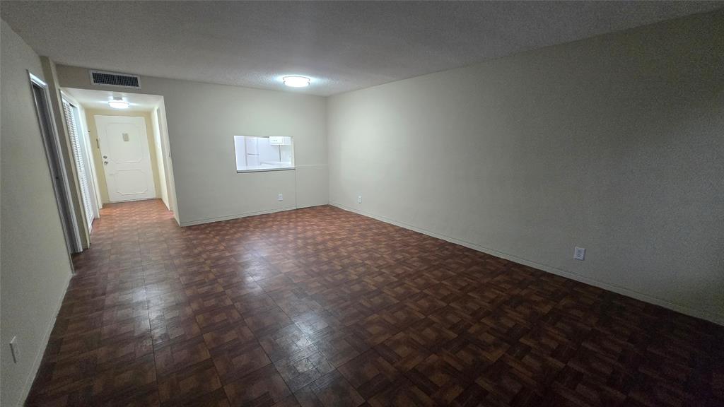 16800 Northeast 15th Avenue, Unit 310 North Miami Beach, FL 33162 - Photo 17 of 23 an empty room with wooden floor and windows