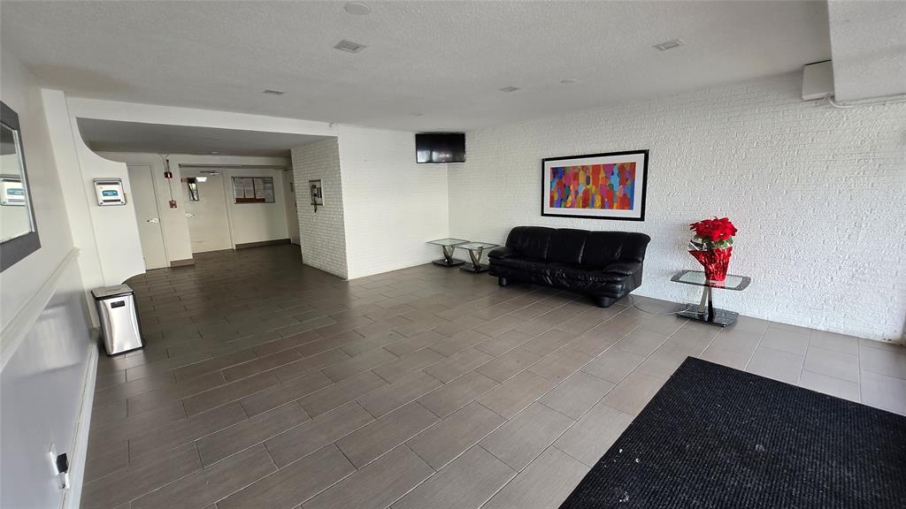 16800 Northeast 15th Avenue, Unit 310 North Miami Beach, FL 33162 - Photo 20 of 23 a living room with furniture and a wooden floor