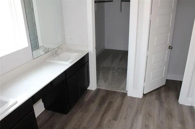 a kitchen with a sink and a mirror