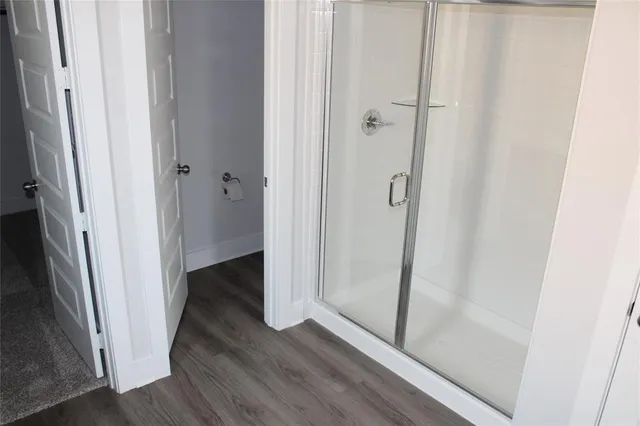 a view of a hallway with wooden floor