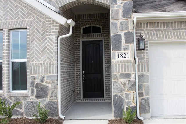 a front view of a building with a potted plant