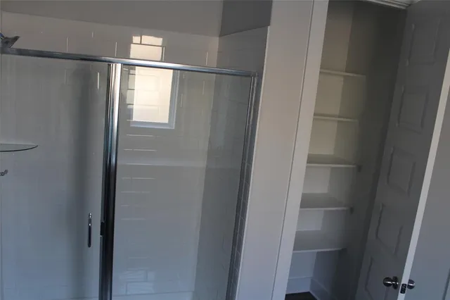 a bathroom with a glass shower door