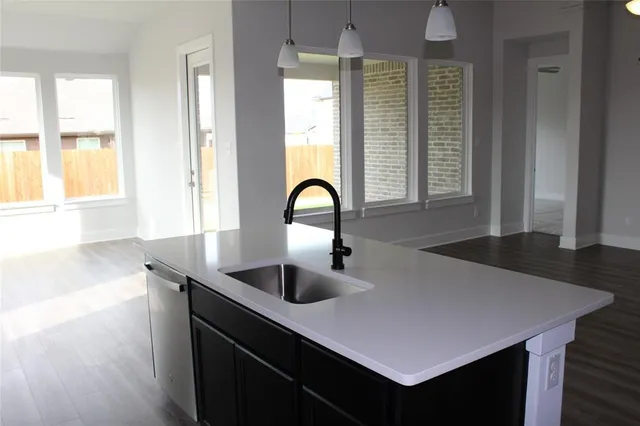 a kitchen with a sink a counter and a dining table