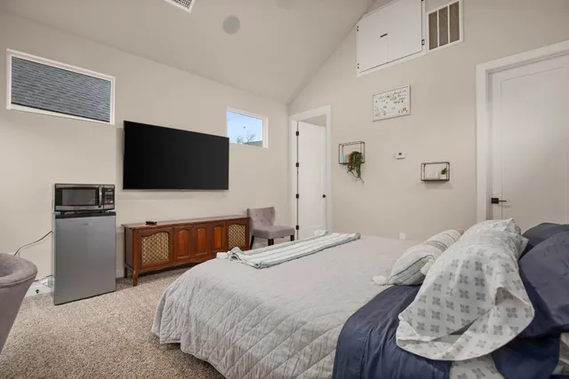a bedroom with a bed and a flat screen tv