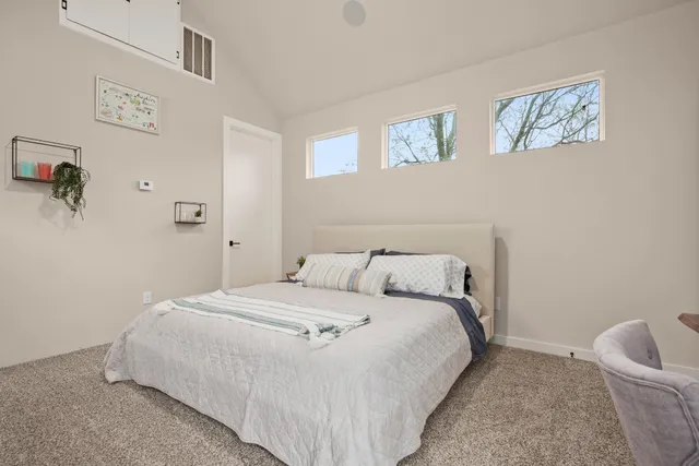 a bedroom with a bed and wall painting