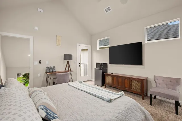 a bedroom with a bed and a flat screen tv