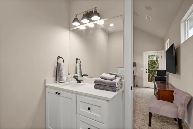 a kitchen with a sink and a mirror