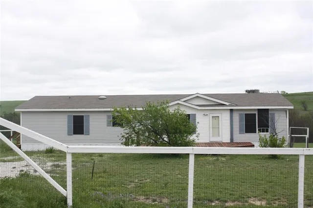 a front view of a house with a yard table and chairs