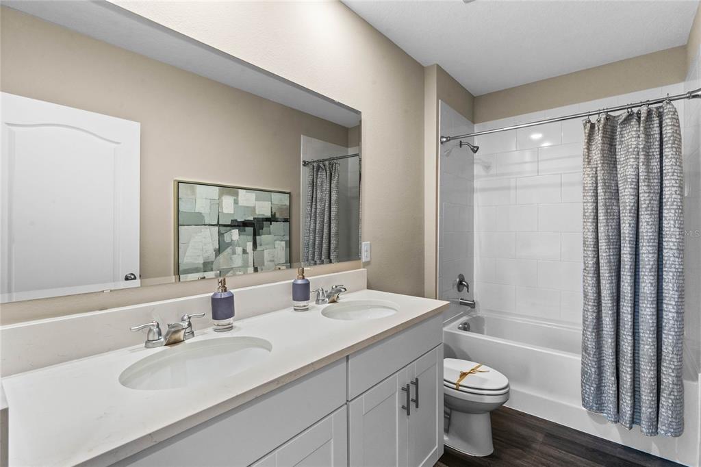 1816 Three Bars Road Kissimmee, FL 34744 - Photo 21 of 59 a bathroom with a sink toilet a mirror and shower