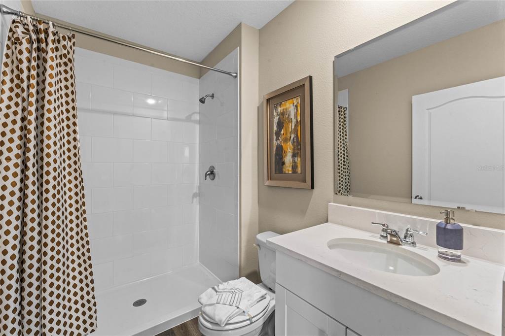 1816 Three Bars Road Kissimmee, FL 34744 - Photo 27 of 59 a bathroom with a sink a toilet and shower