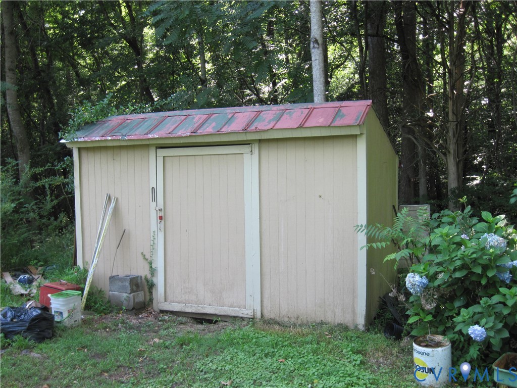 4301 Old Nottingham Road Quinton, VA 23141 - Photo 4 of 9 Utility shed with vertical siding and a red metal