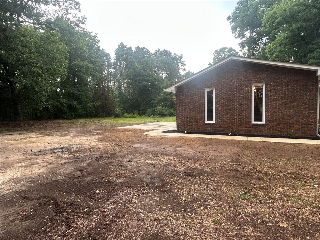 809 Paige Road Honea Path, SC 29654 - Photo 4 of 27 Mature trees surround this brick home with a spacious yard ready for landscaping.
