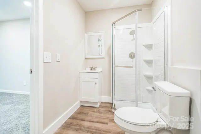 a white toilet sitting next to a bathroom sink