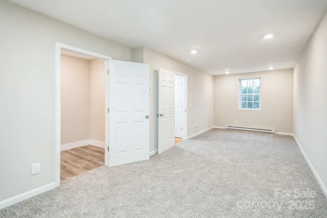 an empty room with windows and closet