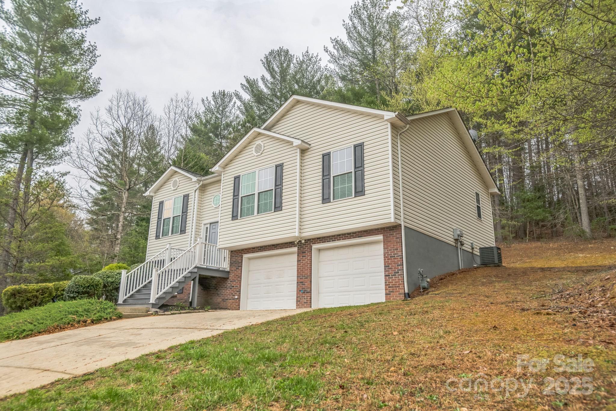 240 Doe Run Morganton, NC 28655 - Photo 4 of 15 a view of a white house with a yard and large tree