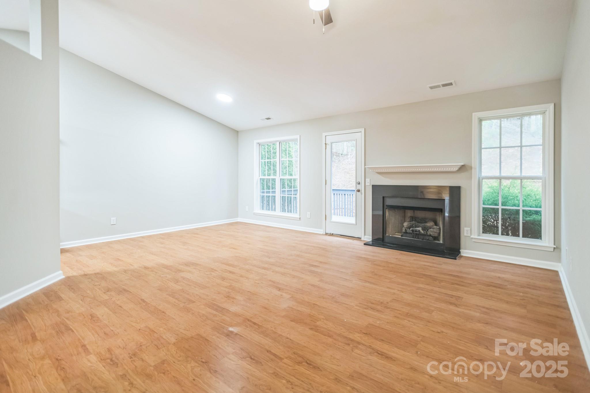 240 Doe Run Morganton, NC 28655 - Photo 8 of 15 a view of empty room with a fireplace and windows