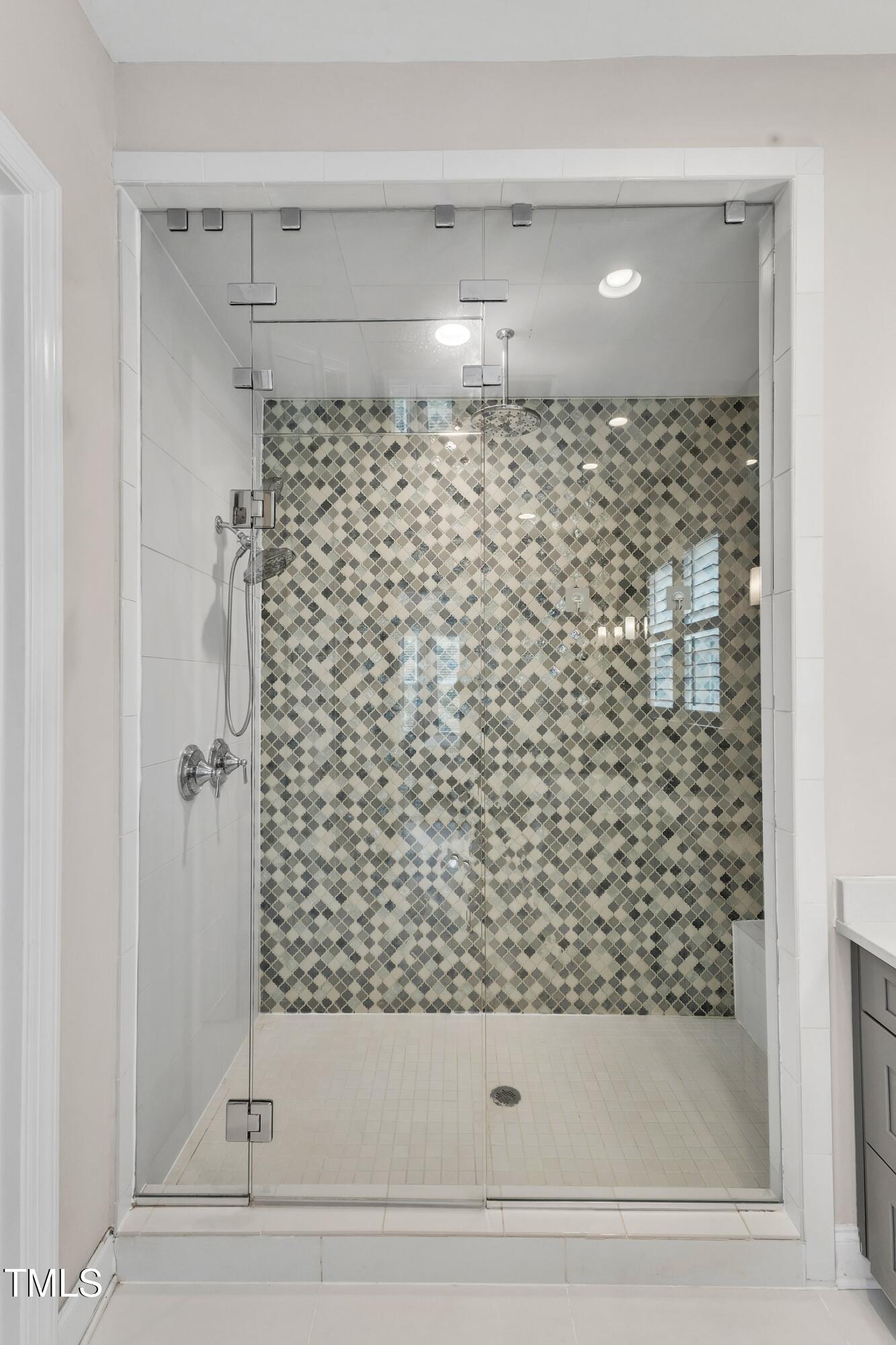 8121 Greys Landing Way Raleigh, NC 27615 - Photo 34 of 95 a bathroom with a bathtub and shower