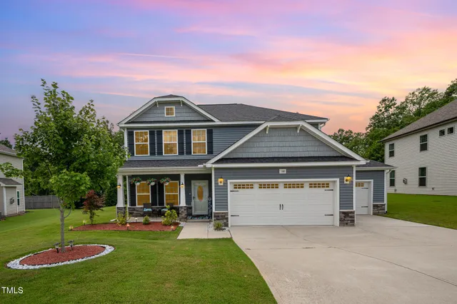 a front view of a house with a yard table and chairs