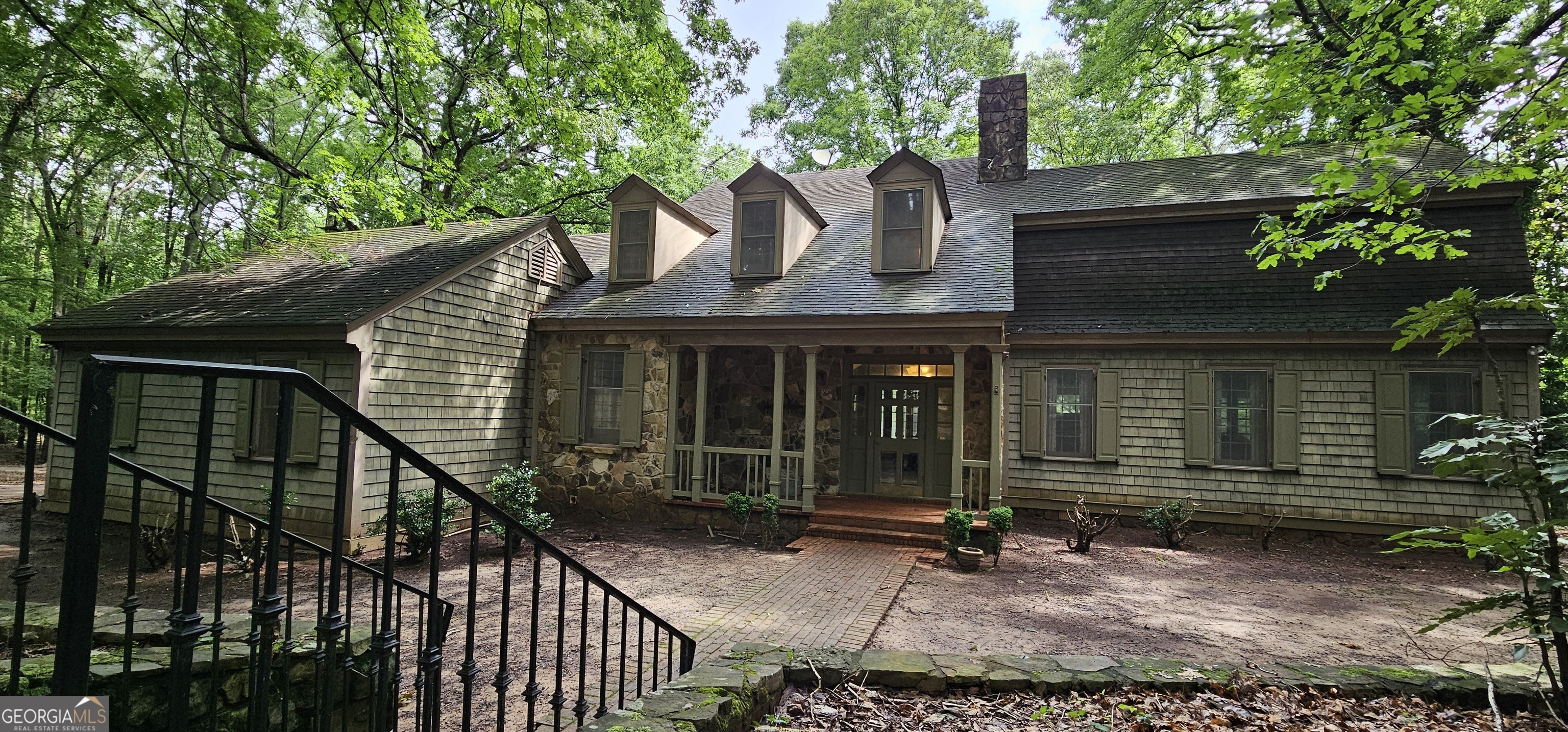 front view of a house with a tree