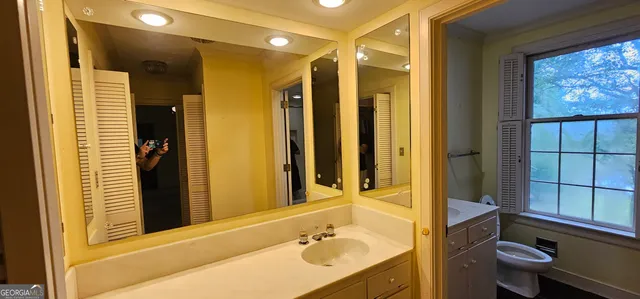 a view of empty room with wooden floor and fireplace