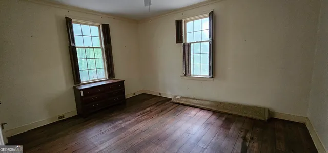 a view of a hallway with wooden floor and entryway