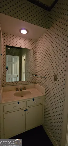 a kitchen with granite countertop a sink and a stove top oven