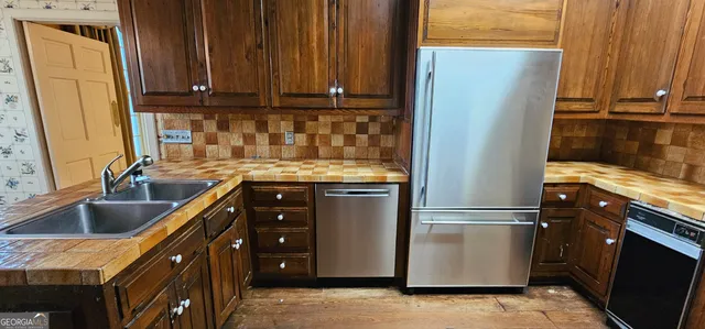 a view of an entryway with wooden floor and door