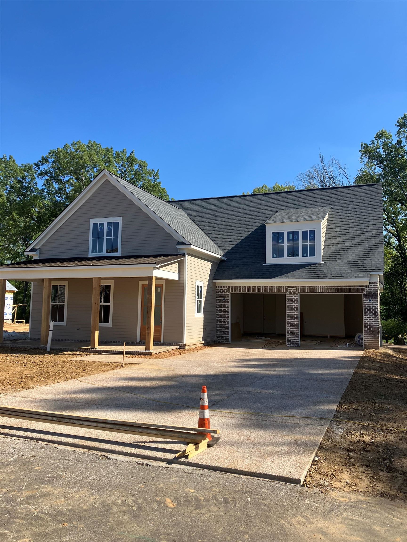 267 Mossberry Lane Collierville, TN 38017 - Photo 2 of 3 View of front of property with driveway, covered porch, roof with shingles, and brick siding