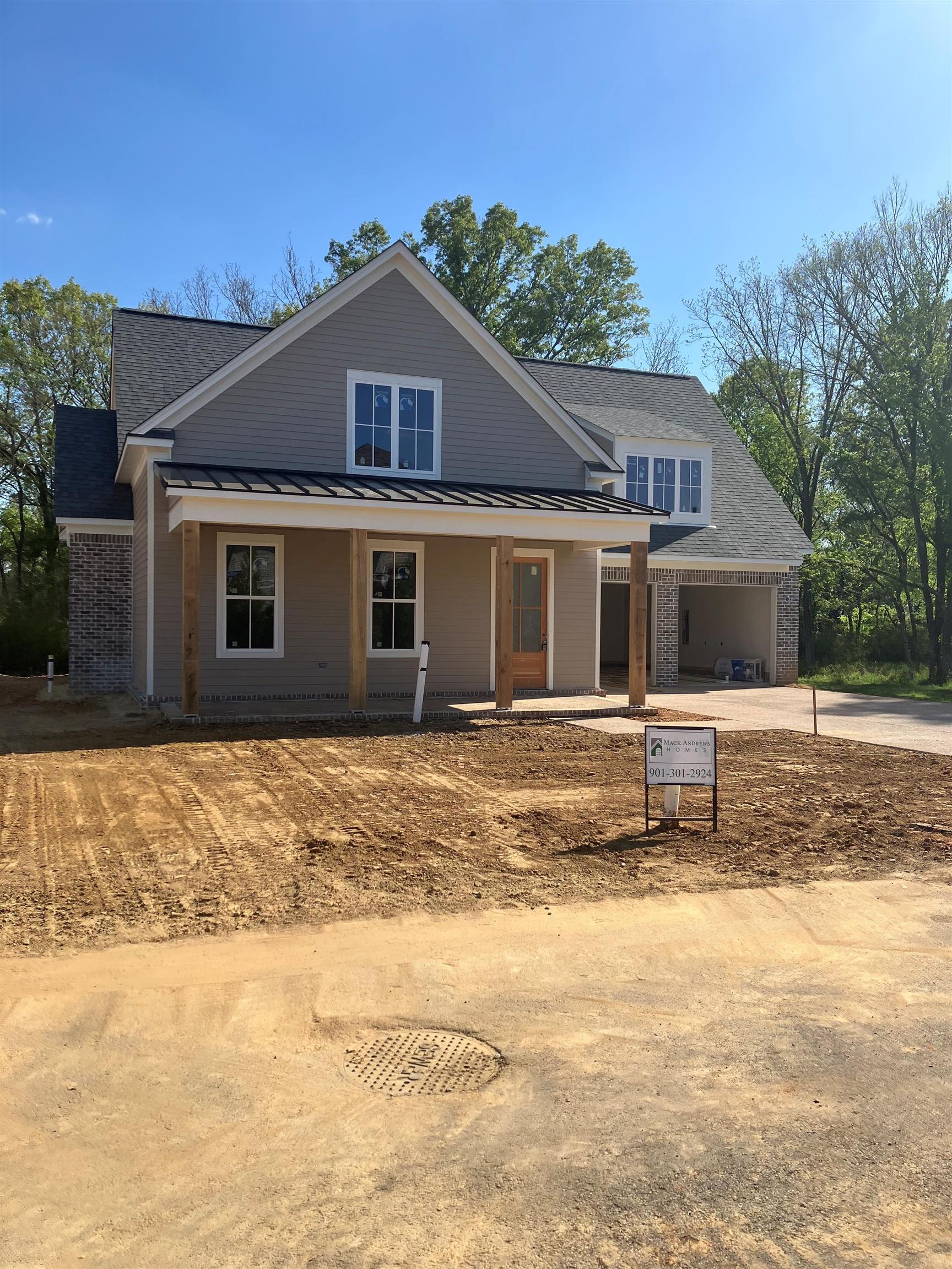 267 Mossberry Lane Collierville, TN 38017 - Photo 3 of 3 View of front of house featuring driveway, a porch, brick siding, and a standing seam roof