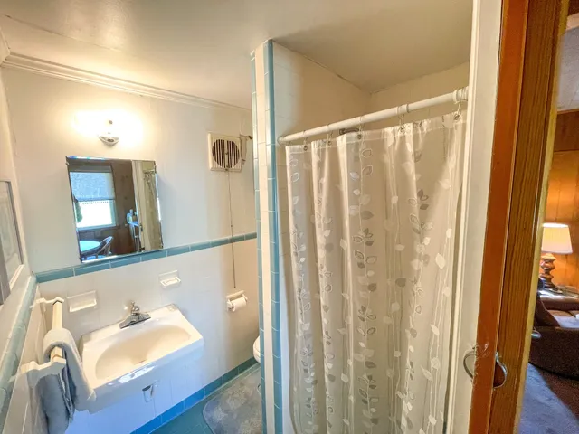 a bathroom with a tub and a mirror