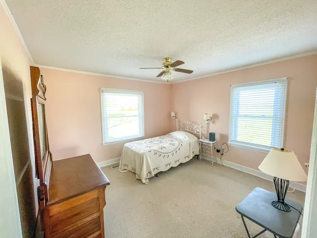 a bedroom with a bed and chair