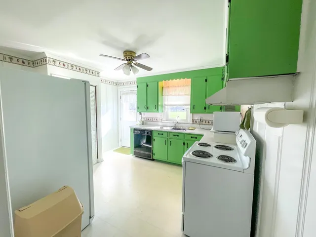 a kitchen with a refrigerator and a sink