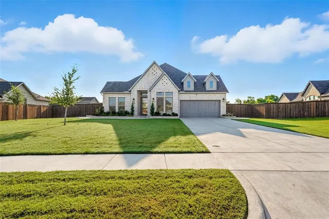 a view of a house with a big yard and potted plants