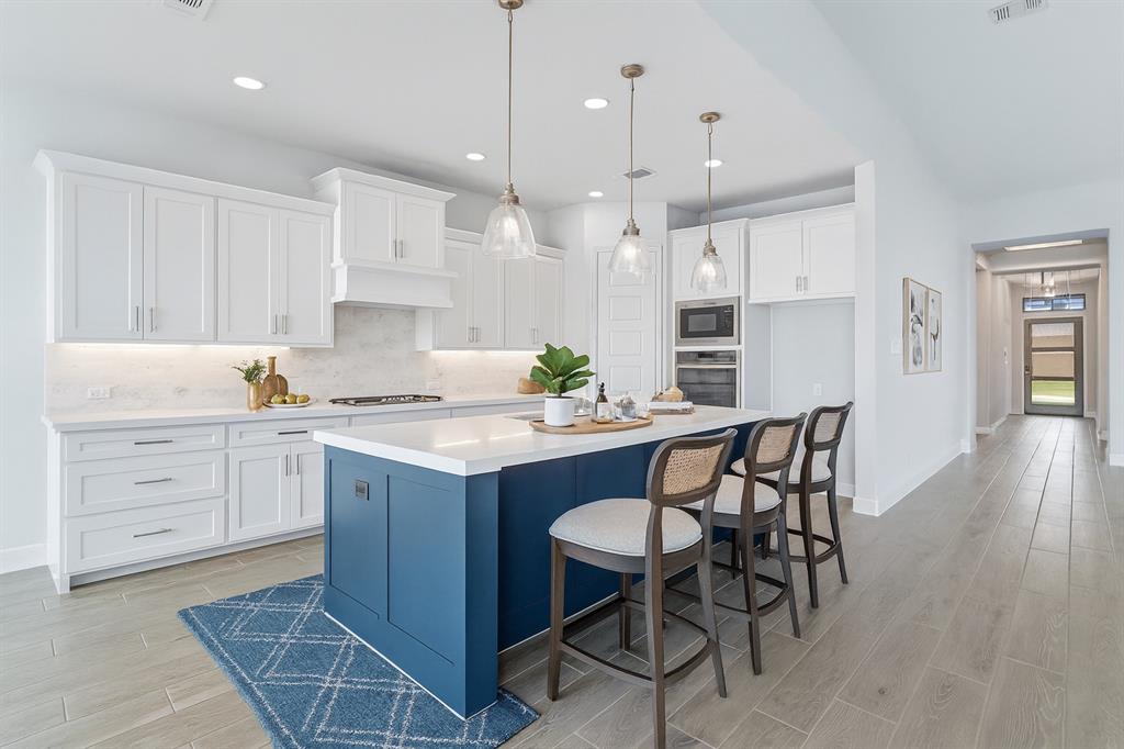 1557 Ripasso Way McLendon-Chisholm, TX 75032 - Photo 14 of 31 a kitchen with kitchen island granite countertop a table chairs sink and cabinets