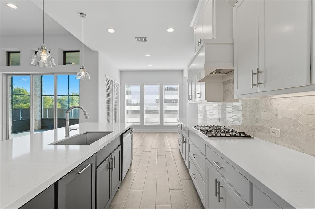 1557 Ripasso Way McLendon-Chisholm, TX 75032 - Photo 16 of 31 a kitchen with stainless steel appliances a sink stove and cabinets