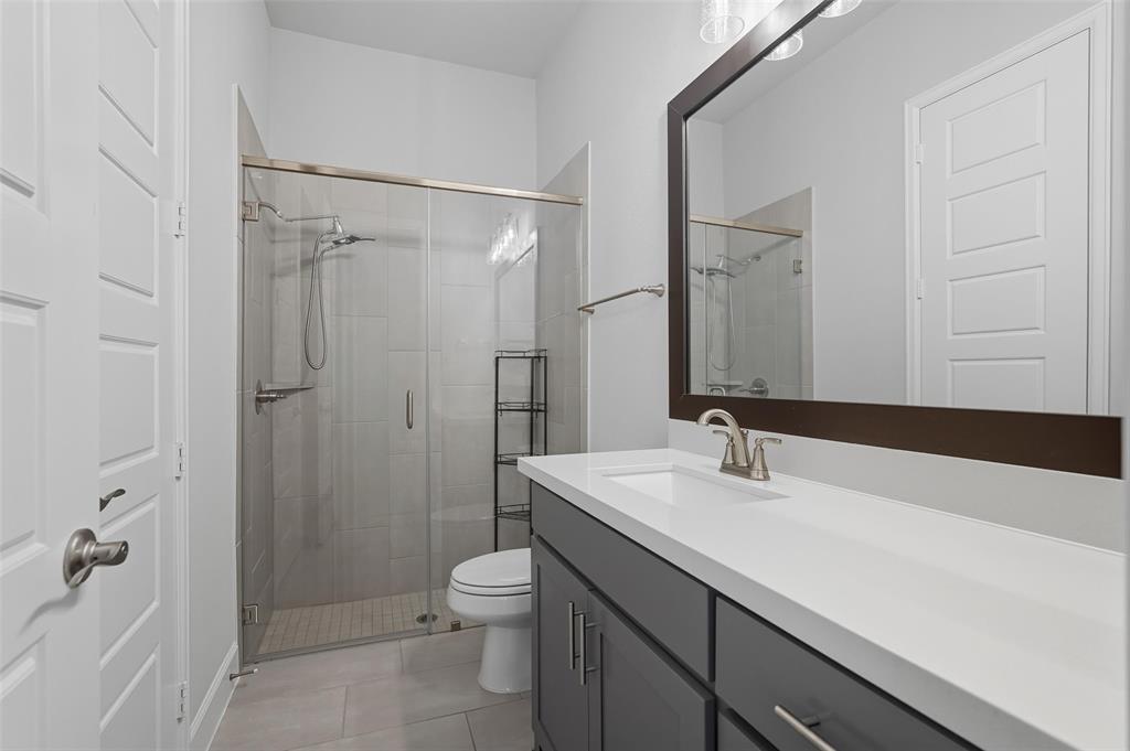1557 Ripasso Way McLendon-Chisholm, TX 75032 - Photo 22 of 31 a bathroom with a sink a toilet and shower