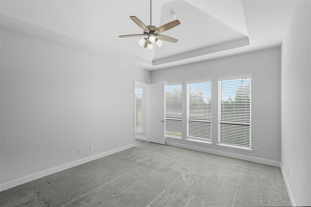 1557 Ripasso Way McLendon-Chisholm, TX 75032 - Photo 25 of 31 an empty room with chandelier fan and windows