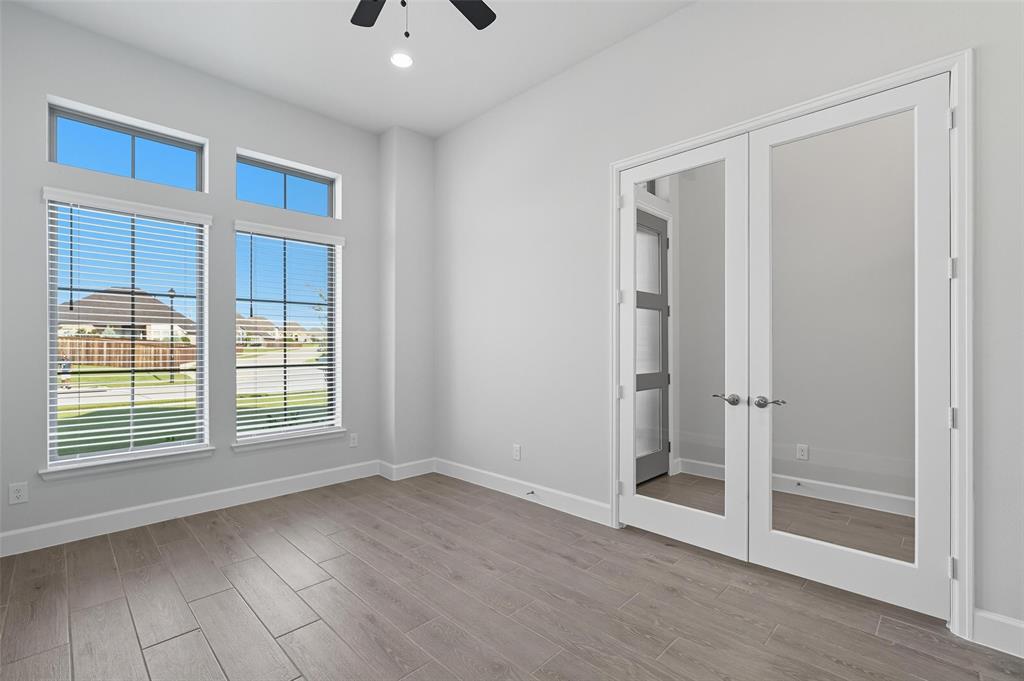 1557 Ripasso Way McLendon-Chisholm, TX 75032 - Photo 3 of 31 a view of an empty room with wooden floor and a window