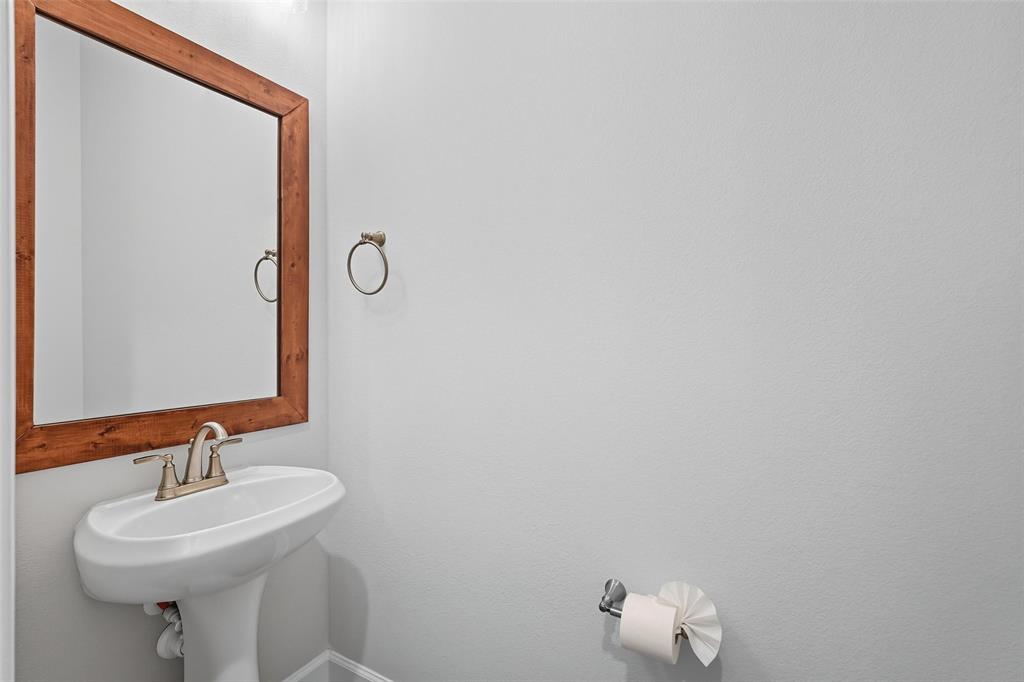 1557 Ripasso Way McLendon-Chisholm, TX 75032 - Photo 7 of 31 a bathroom with a sink mirror and toilet