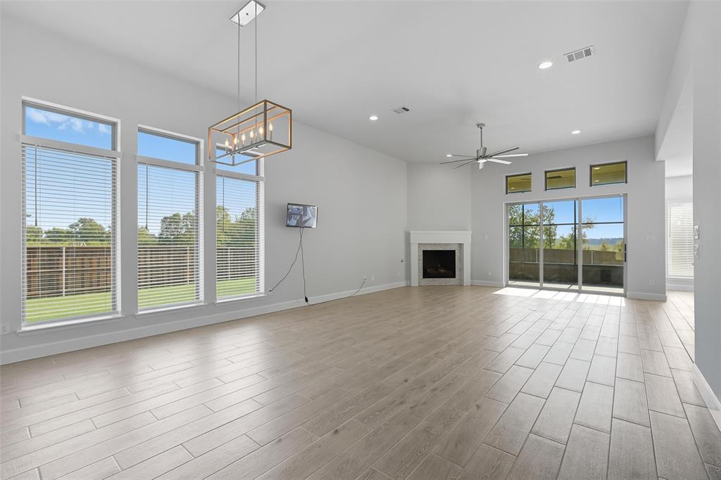 1557 Ripasso Way McLendon-Chisholm, TX 75032 - Photo 10 of 31 a view of an empty room with wooden floor and a window